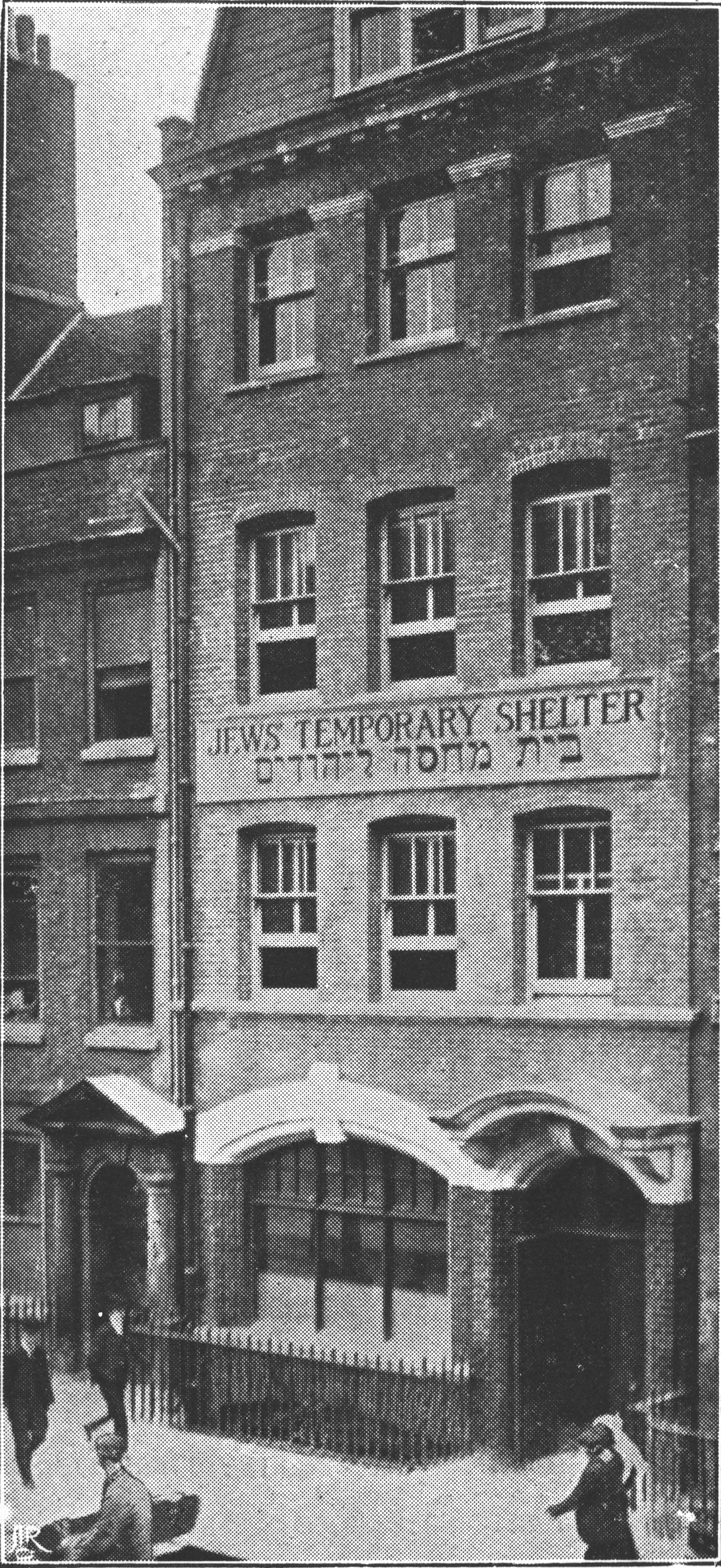 Black and white image of a tall building with a sign saying Jews Temporary Shelter