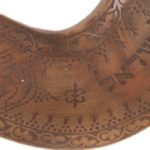 Close up of shofar showing foliage pattern and Hebrew text