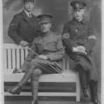 Black and white photo of three men in army uniforms.