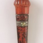 Detail of the silver-gilt flower on the knife's amber handle.