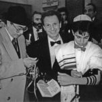A black and white photograph of a boy laying Tefillin at his Bar Mitzvah