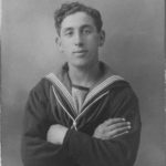 A black and white photo of a man in a sailor's outfit.