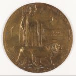 A bronze circular medal with a lion and Britannia on the front.