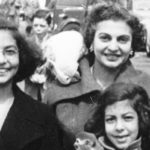 A black and white photograph of a mother and two daughters.