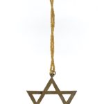 A metal Magen David (Star of David) pendant on a piece of twine
