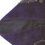 Edge of blue velvet fabric with black underside