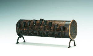 Reverse side of a wooden Hanukah Lamp with arms for candles and Trench Art engraving