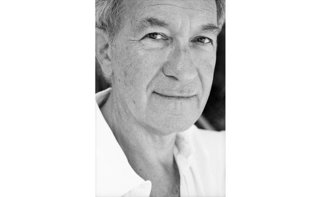 Portrait of older gentleman in white shirt smiling. Simon Schama - Image credit Margherita Mirabella