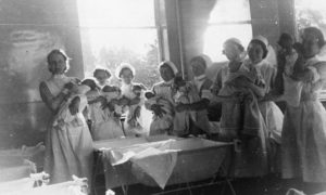 B&W image of a group of women in nurses uniforms