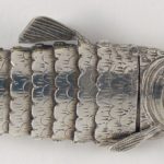 Detail of fins and scales of the silver fish shaped spice box