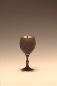 A goblet made from a brown wooden shell 