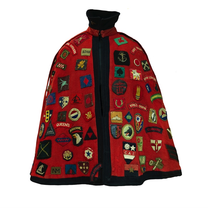 A red cape with badges on it
