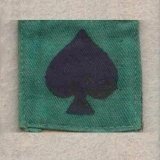 A green cloth with a black spade on it