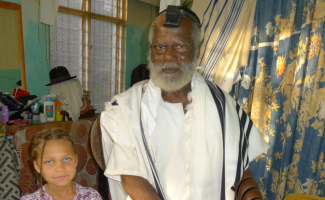 grandfather and granddaughter, wearing Tefillin, Ghana