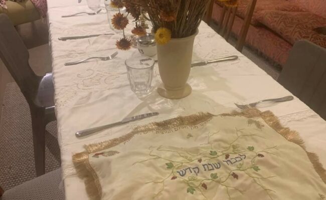 Shabbat Table with decorative handmade challah cover.